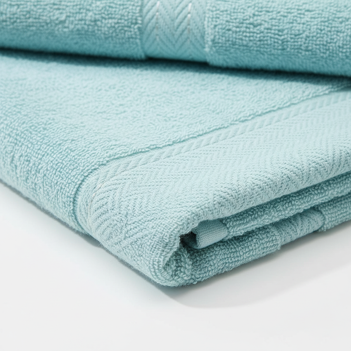 Arrangement of 10-piece luxury towel set, including bath, hand, and face towels, in a light-filled bathroom.