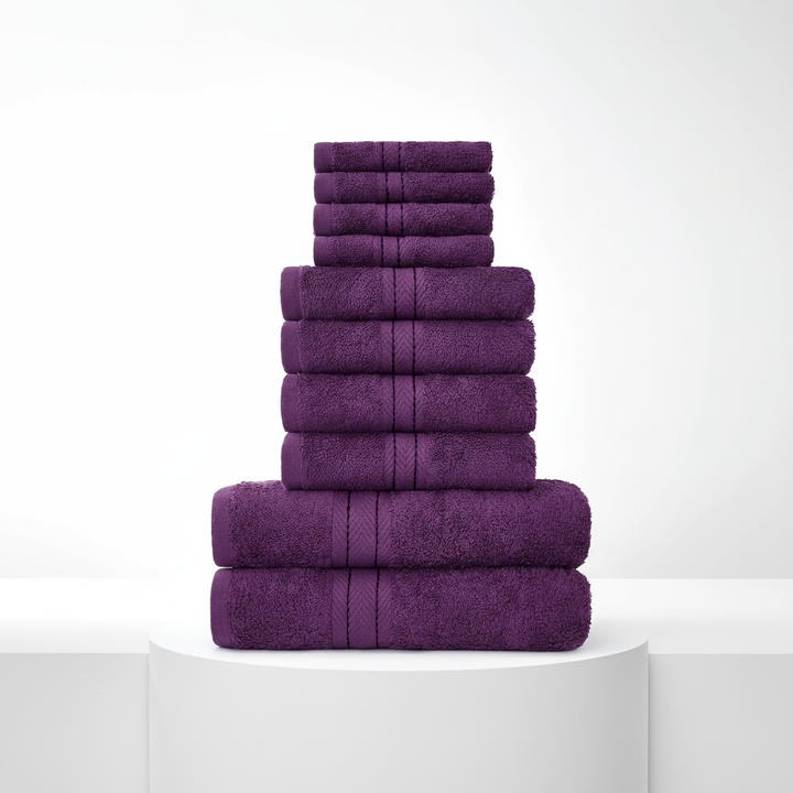 Collection of pristine white cotton face towels, folded and ready for use, part of a luxury set.