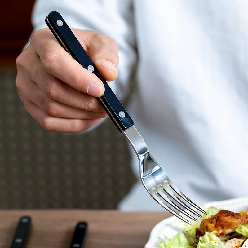 Premium 24-piece engraved stainless steel cutlery, perfect elegant tableware collection.