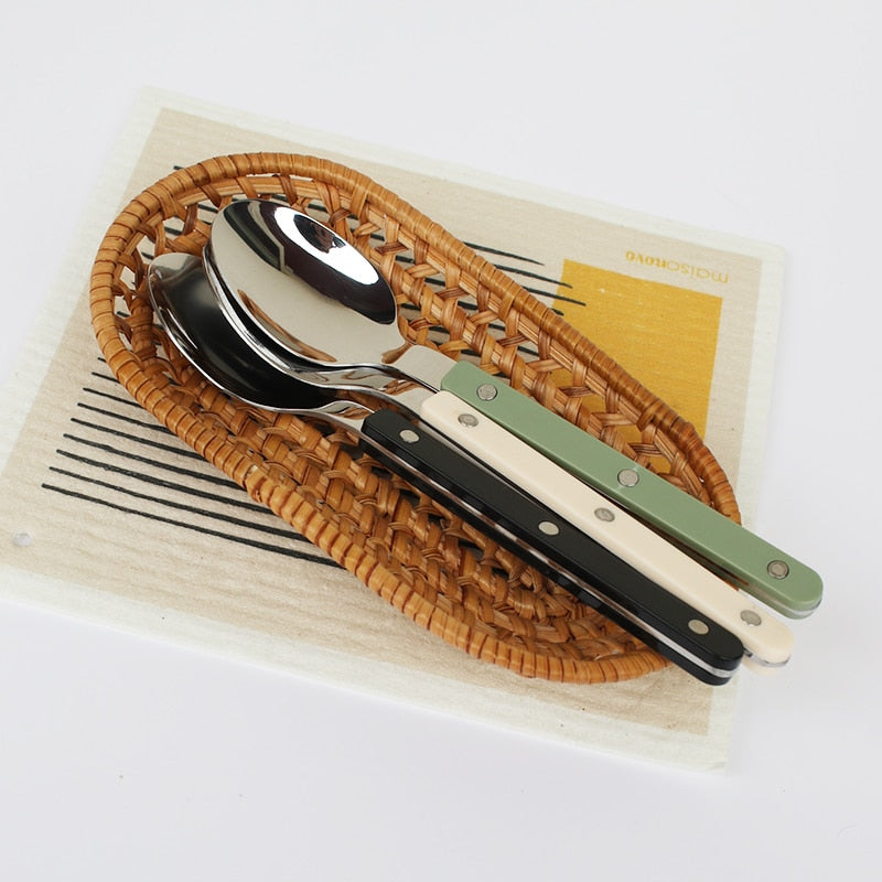 Engraved 24-piece stainless steel cutlery set, ideal for any dining table setting.