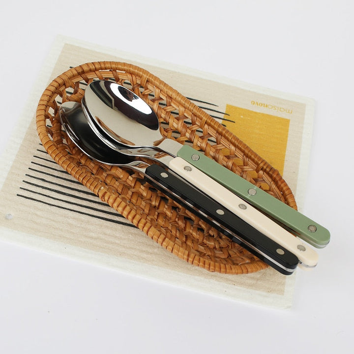 Engraved 24-piece stainless steel cutlery set, ideal for any dining table setting.