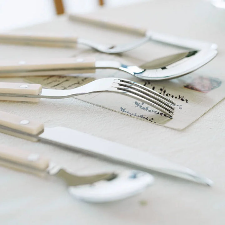 Modern elegant 24-piece engraved stainless steel cutlery set for contemporary dining.
