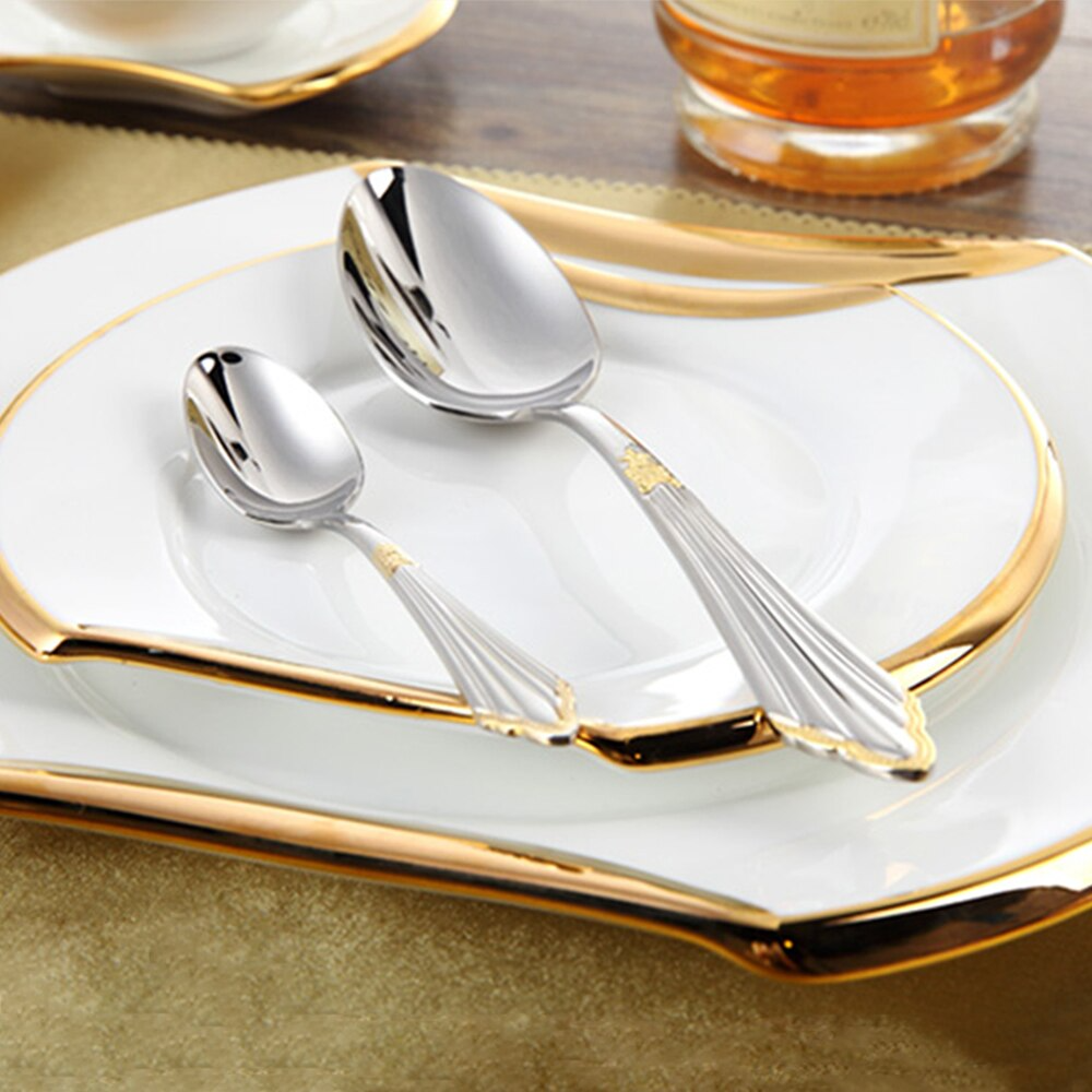 Gold stainless steel cutlery set beautifully arranged on a dining table, ideal luxury flatware for guests.