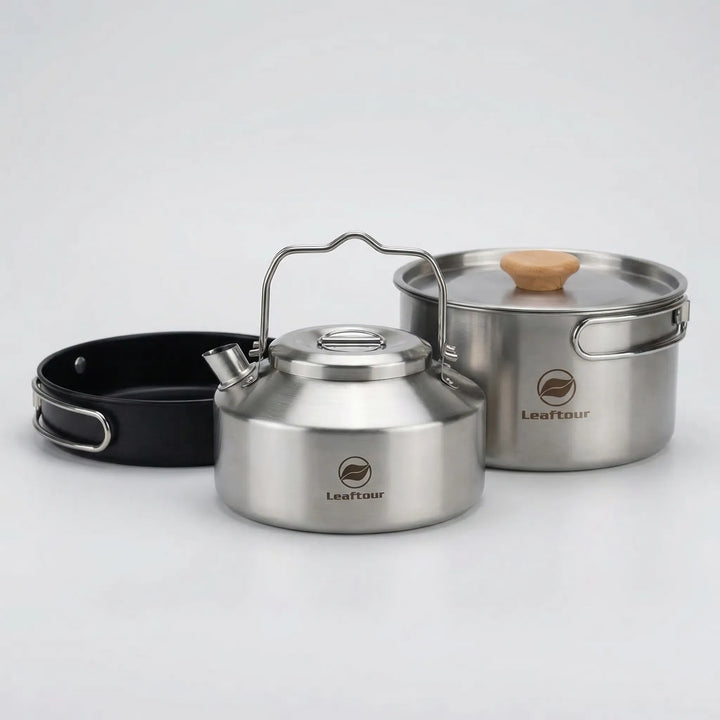 Compact 3-piece camping cookware set with nonstick pot, frying pan, & lid for outdoor cooking & camp stoves.