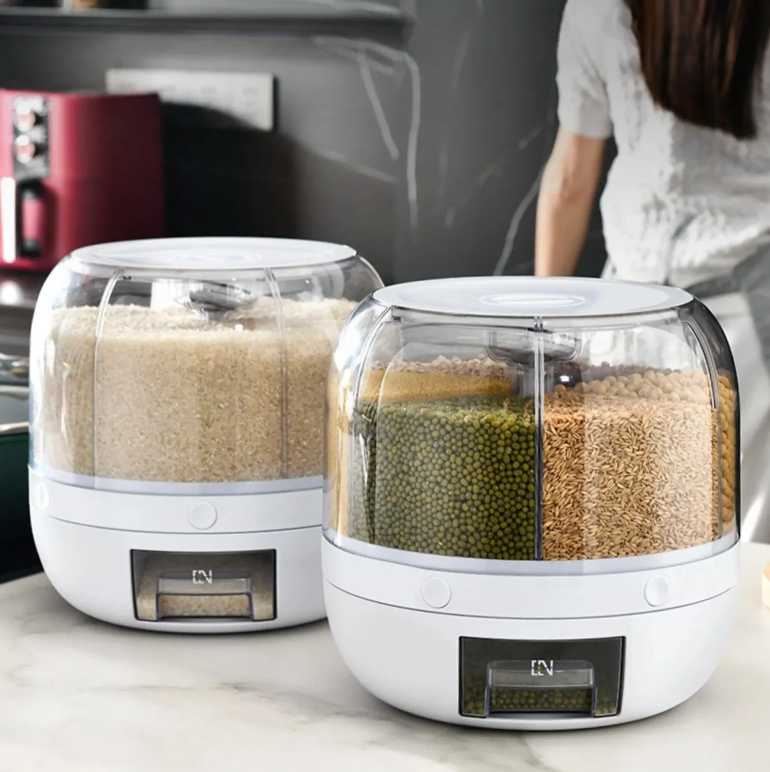 Clear rotating dry food dispenser showing multiple compartments filled with cereals, oats, and rice.