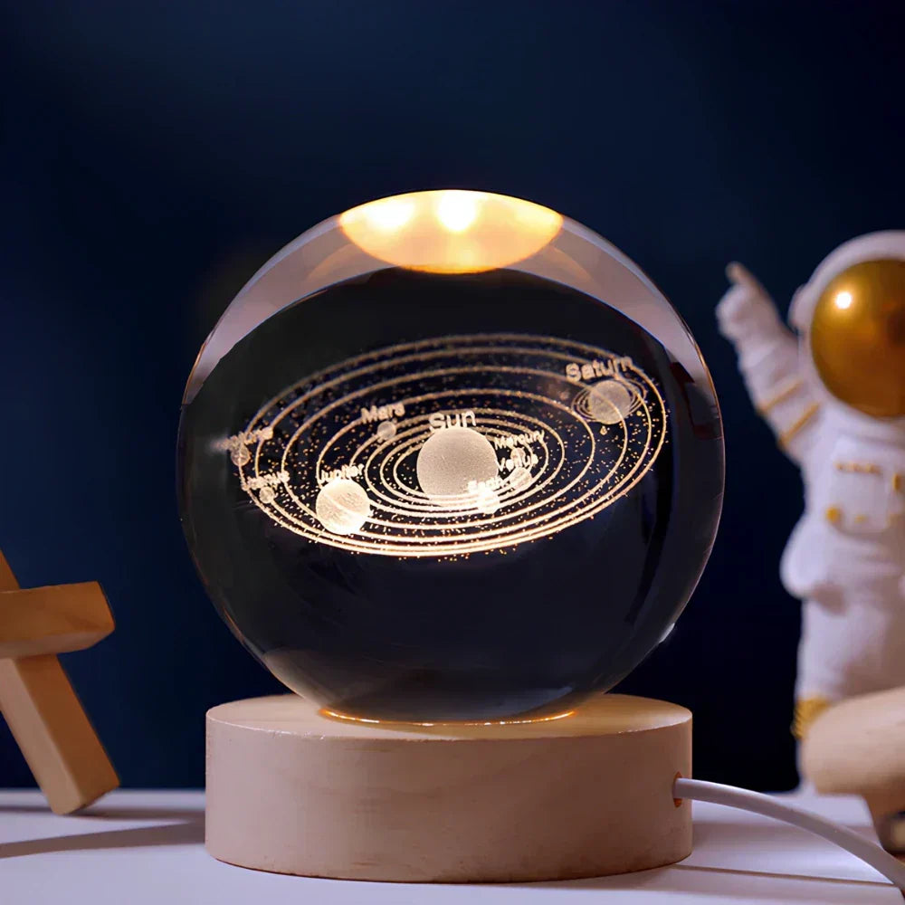 Unisex 3D engraved crystal sphere night light illuminating a dark room, creating a celestial mood