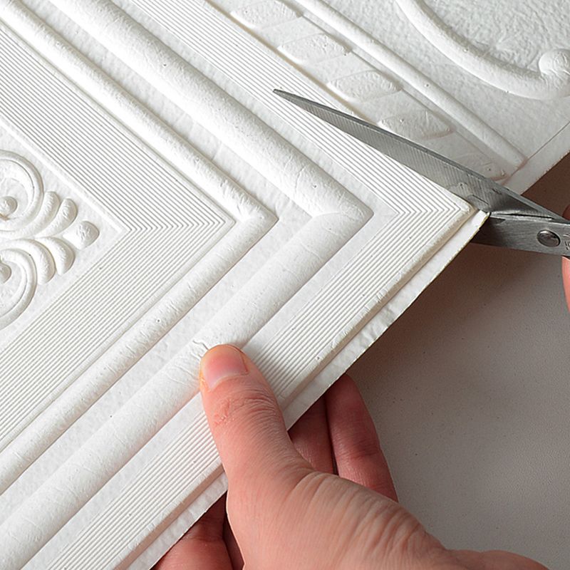 White 3D vinyl wall panels, self-adhesive, providing a contemporary textured wall decor solution.