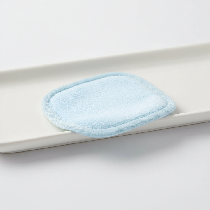 Reusable facial cleansing pad demonstrating its flexibility and softness for effective skincare