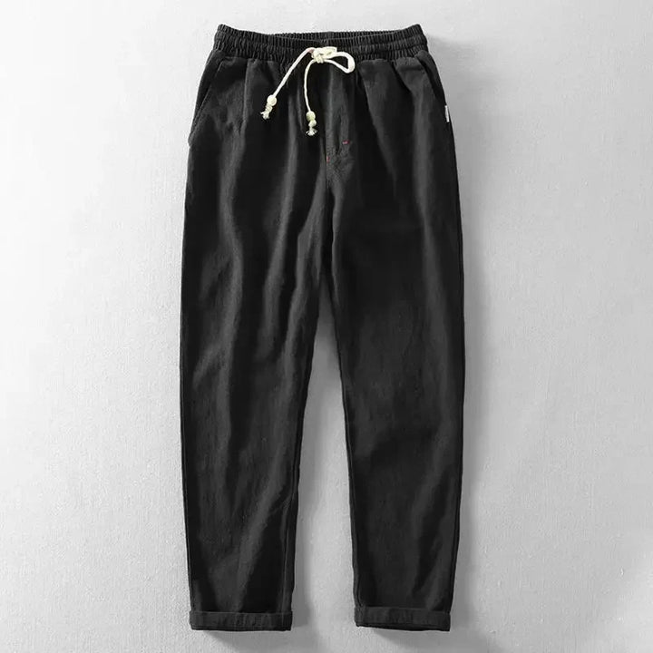 Stylish man modeling Zen trousers, emphasizing their relaxed fit and modern men's fashion appeal.