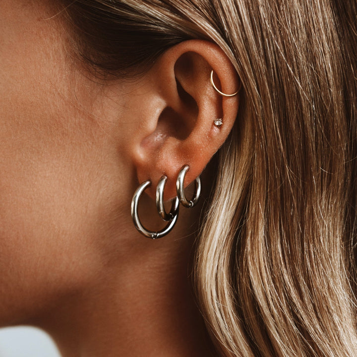Timeless silver hoop earrings for women, a versatile jewelry accessory, displayed elegantly for product view.