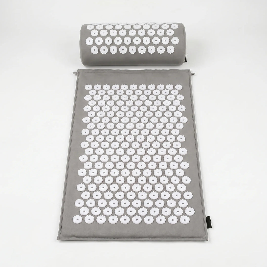 Blue acupressure mat and pillow, featuring thousands of spikes for therapeutic massage, improving circulation & wellness.