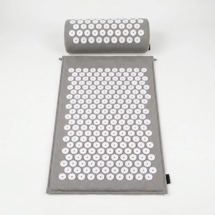 Blue acupressure mat and pillow, featuring thousands of spikes for therapeutic massage, improving circulation & wellness.