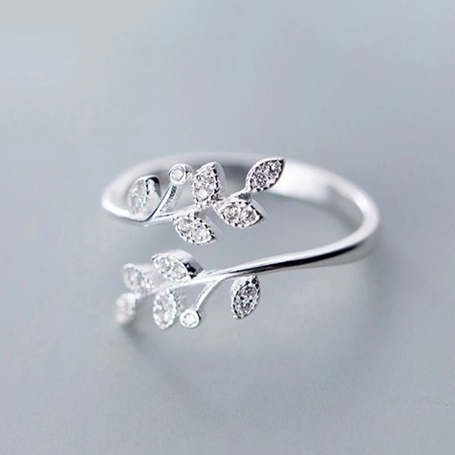 Adjustable silver leaf ring for women, adorned with sparkling zirconia, inspired by nature's beauty.