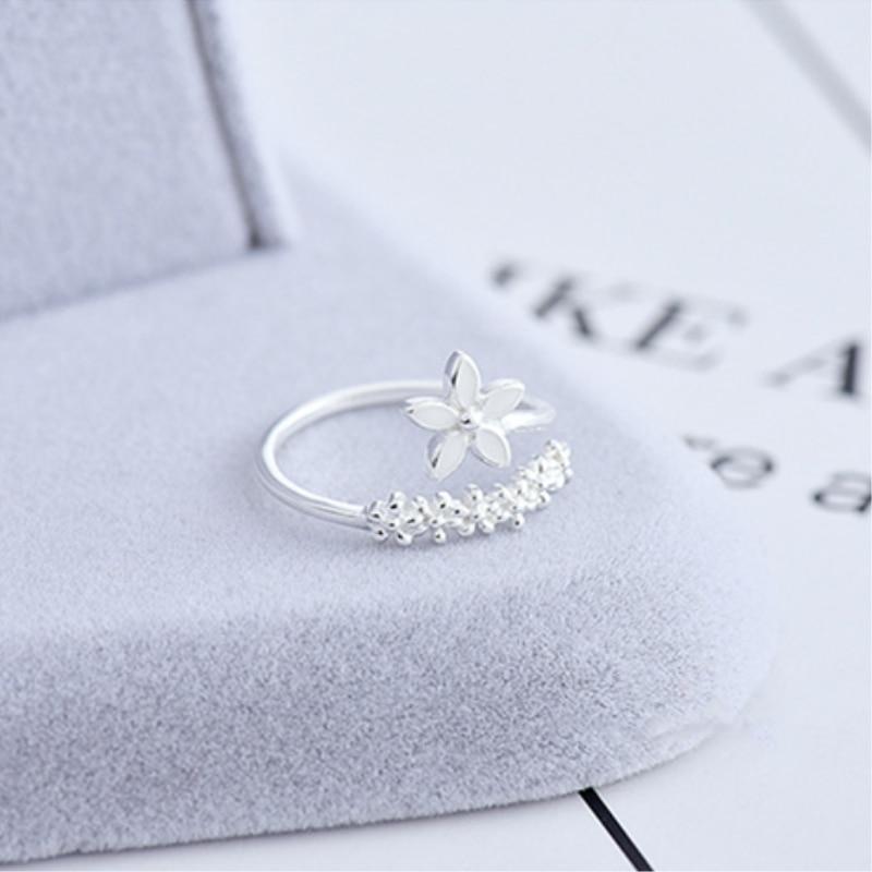 Handmade women's adjustable silver ring featuring vibrant enamel wildflowers. Elegant nature-inspired floral jewelry.