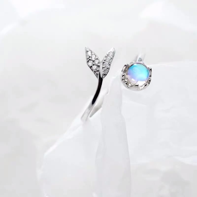 Elegant women's silver ring featuring an adjustable dolphin tail design & a dazzling blue zirconia.