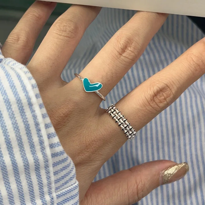 Adjustable women's silver heart ring with a sparkling blue teardrop accent. Elegant jewelry gift for her.