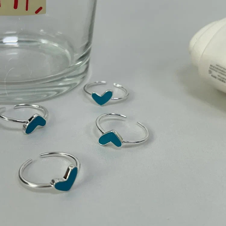 Sterling silver heart ring for women, featuring a vibrant blue drop, adjustable for a perfect fit. Romantic jewelry.