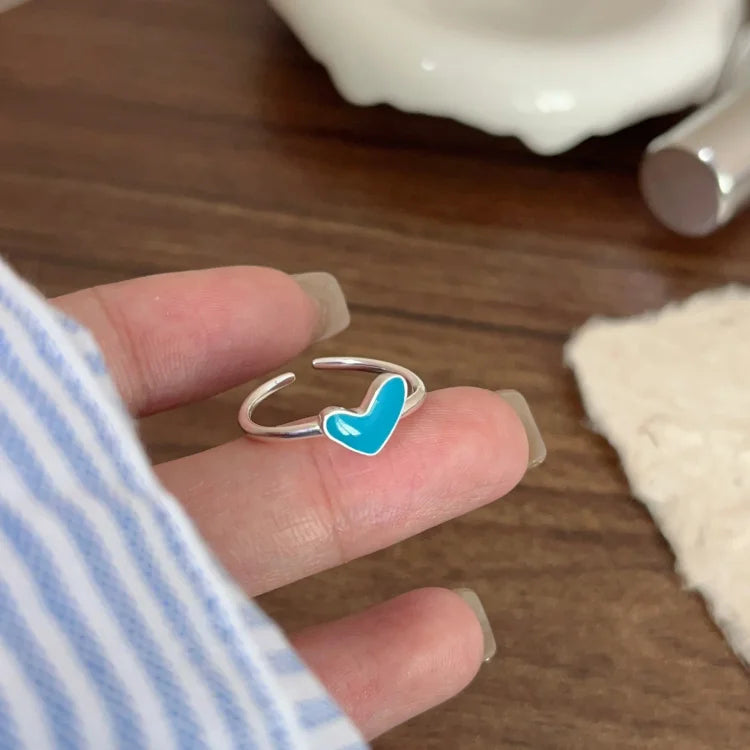 Women's adjustable silver heart ring with a striking blue drop, ideal elegant jewelry or romantic gift.