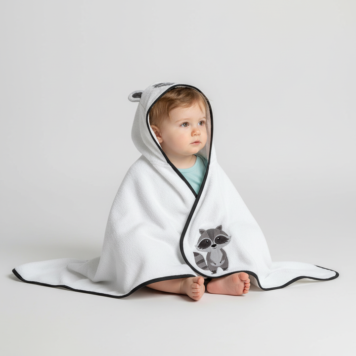 Toddler model showcasing an animal-themed hooded bath towel, emphasizing its fun design and absorbency.