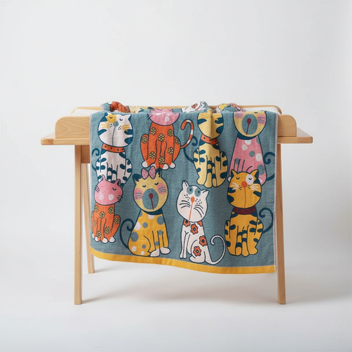 Close-up of a cozy cotton baby bath towel with a cute kitty hood, perfect for kids after a bath.