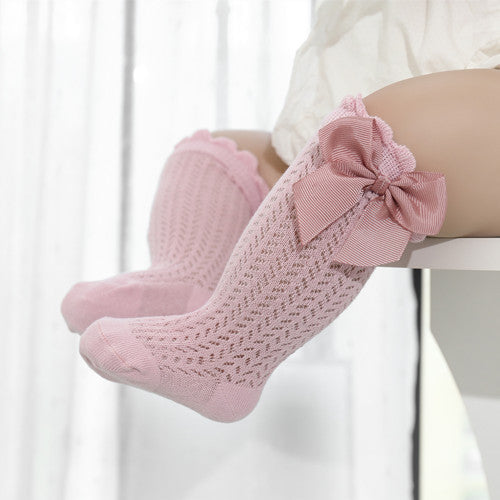 Soft baby cotton socks with a charming large bow detail, essential for newborns, ensuring comfort and style for little feet.