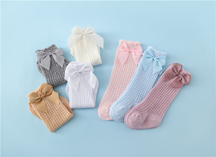 Stylish baby cotton socks featuring an oversized bow, perfect for special occasions or everyday infant fashion, gentle on feet.