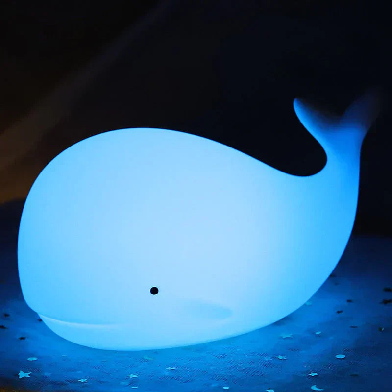 Charming whale night light, a thoughtful children's gift. Features color-changing LED glow for soothing nursery decor.