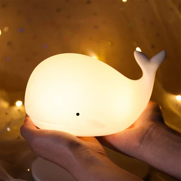 Soft silicone whale night light provides a gentle, color-changing LED glow, perfect for comforting kids at bedtime.