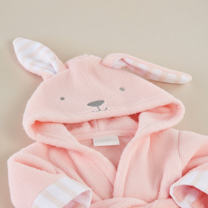 Toddler wrapped in an absorbent SnuggleTowel hooded bath towel after bath, cozy cotton blend