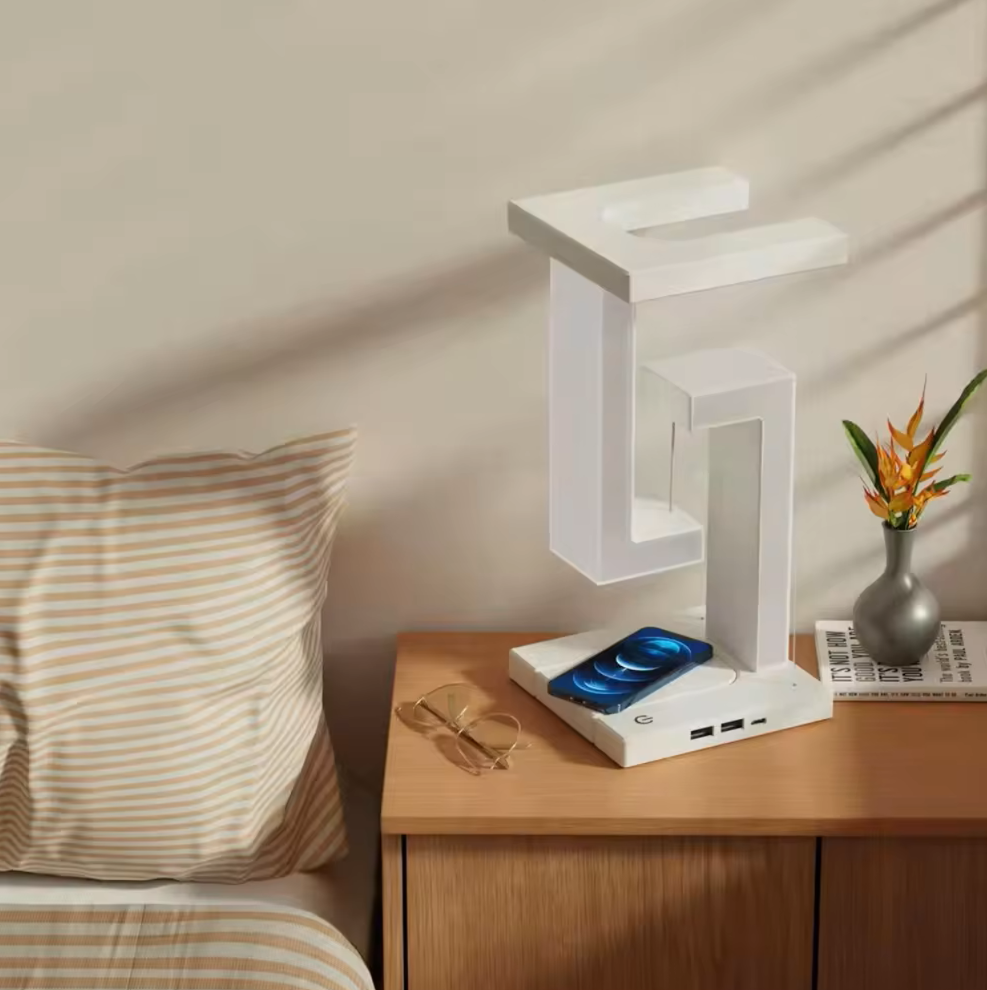 Close-up of the AetherGlow wireless charging pad on a desk lamp base, ready for smartphone charging.