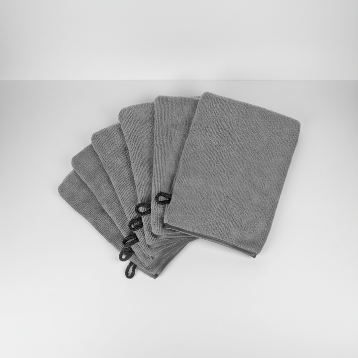 AquaJoy wash mitt set in use, gently cleansing skin, showing its soft coral fleece material