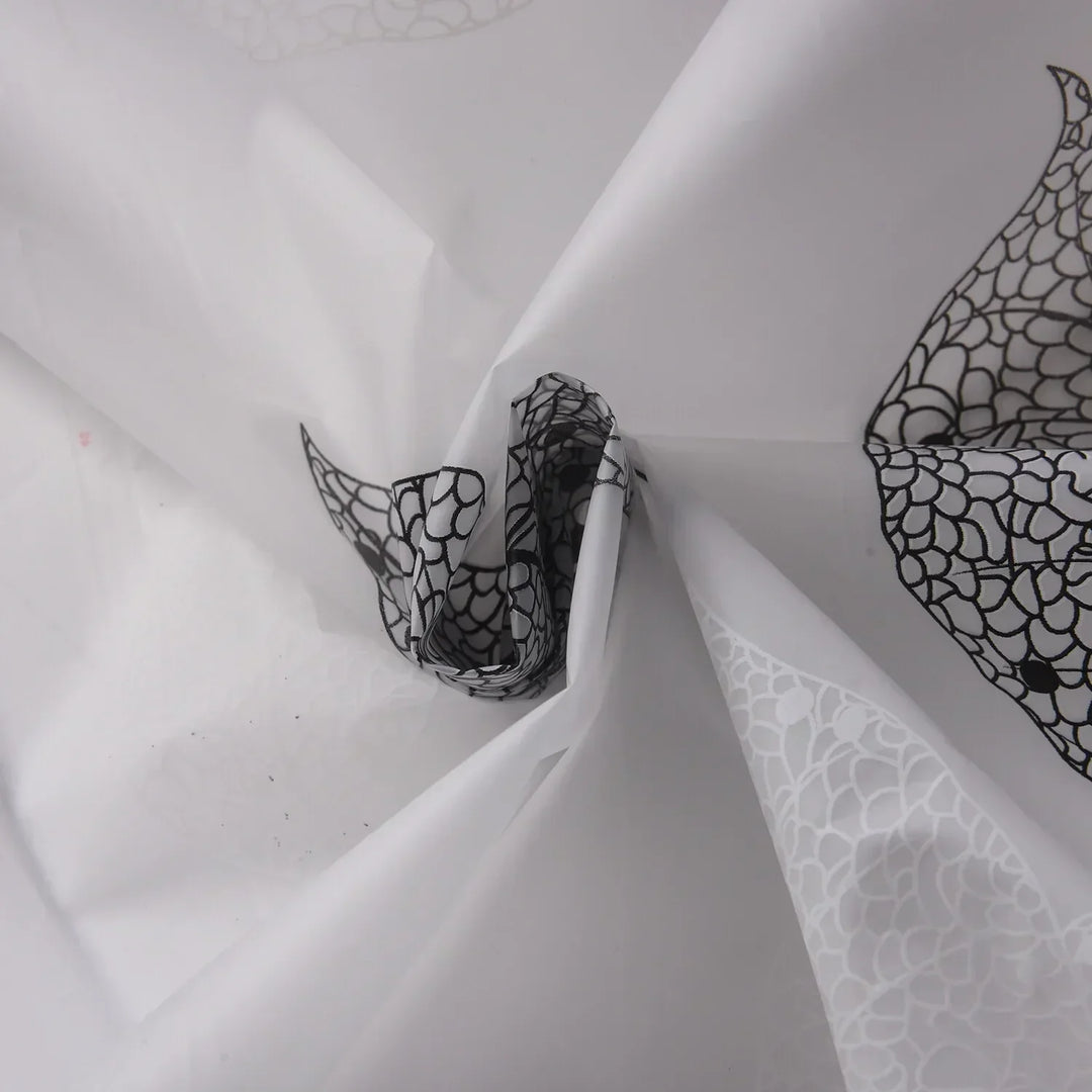 Close-up of AquaLeaf shower curtain fabric, highlighting leaf pattern and transparent material