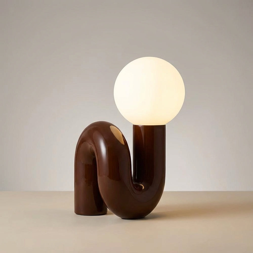 Modern Arcavita sculptural table lamp, ambient light for stylish living room.