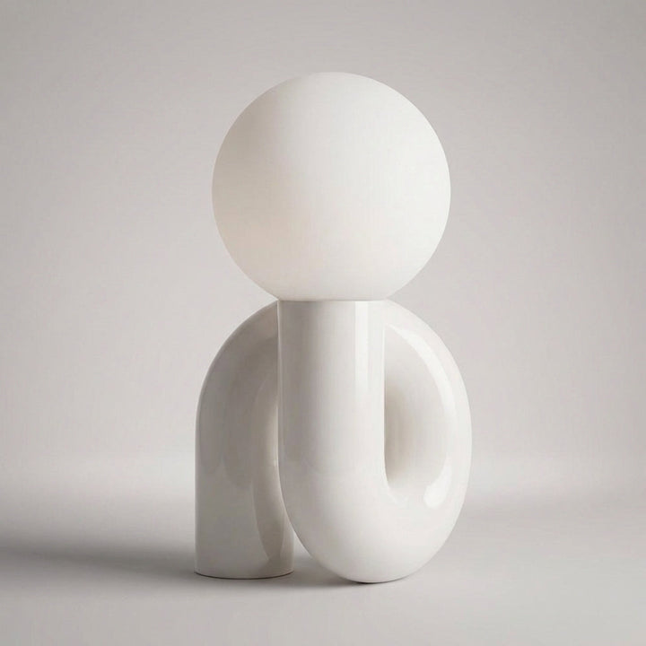 Stylish Arcavita sculptural table lamp with frosted globe, modern lighting solution.
