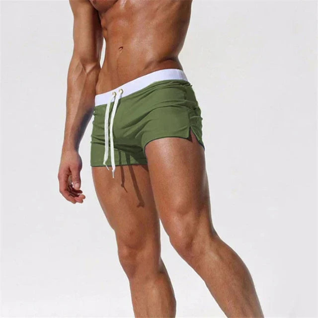 Model engaging in water sports, wearing Arlan men's quick-drying swim shorts for comfort