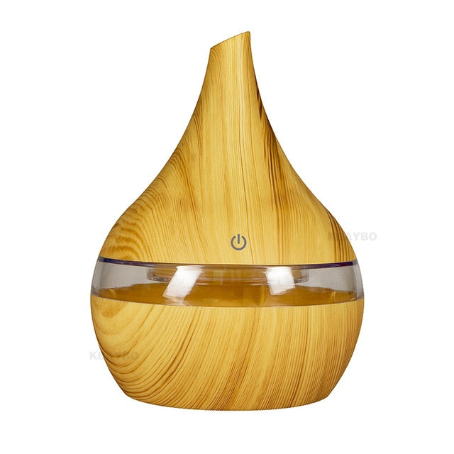 Compact AromaGlow essential oil humidifier with multi-color LED light for improved air and ambiance.