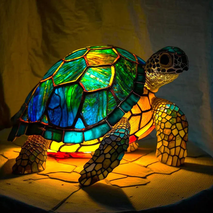 Close-up of the intricate patterns on a stained glass animal art lamp.
