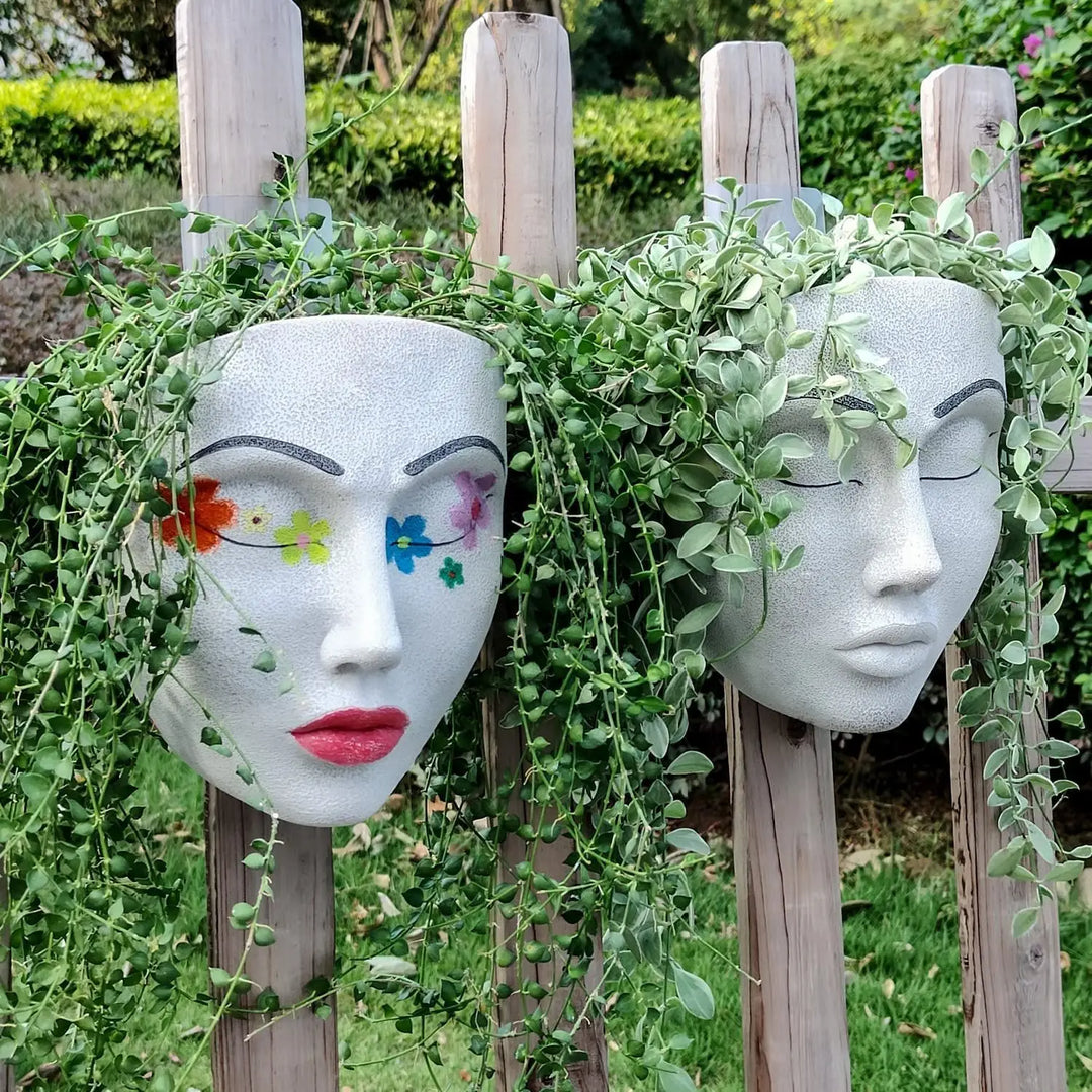 Artistic human face hanging wall planter, durable resin, perfect for indoor plants & modern home decor. Unique accent.