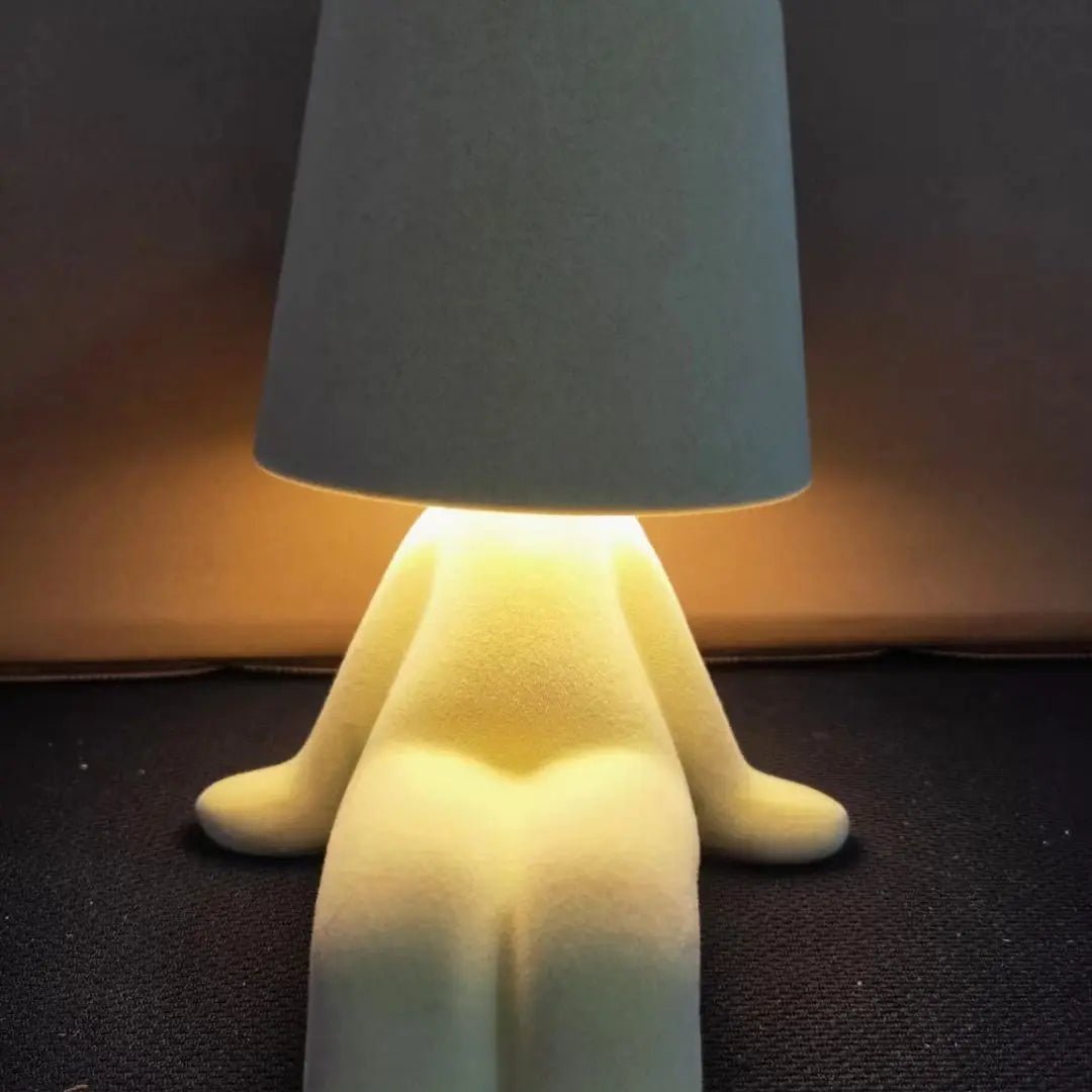 Contemporary human figure LED table lamp. Artistic modern decor, versatile for desk & room lighting.