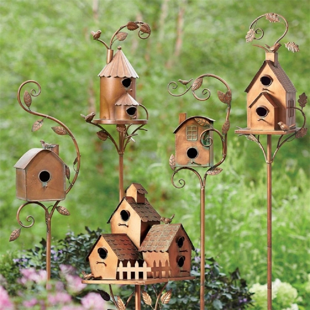 Unique metal birdhouse garden stake, an artistic outdoor living decor piece for any garden.
