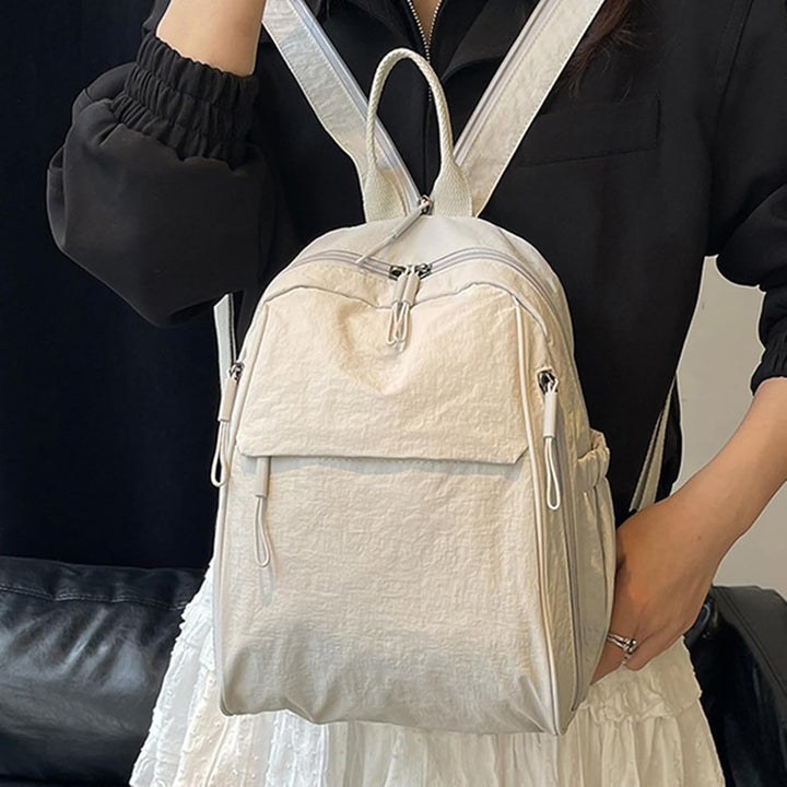 Arvion waterproof casual backpack, durable nylon material, shown with books and laptop inside