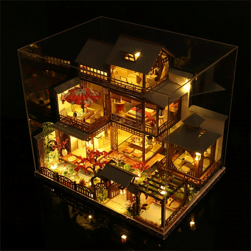 Hands building a large wooden dollhouse miniature kit. Engaging DIY model building hobby for adults & children.
