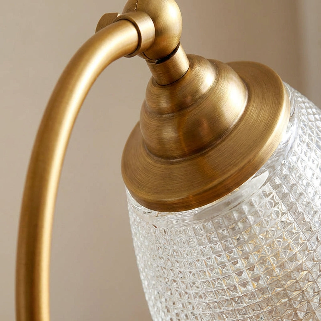Close-up of Women's Vintage Curved Table Lamp, highlighting the metallic finish and intricate design details.