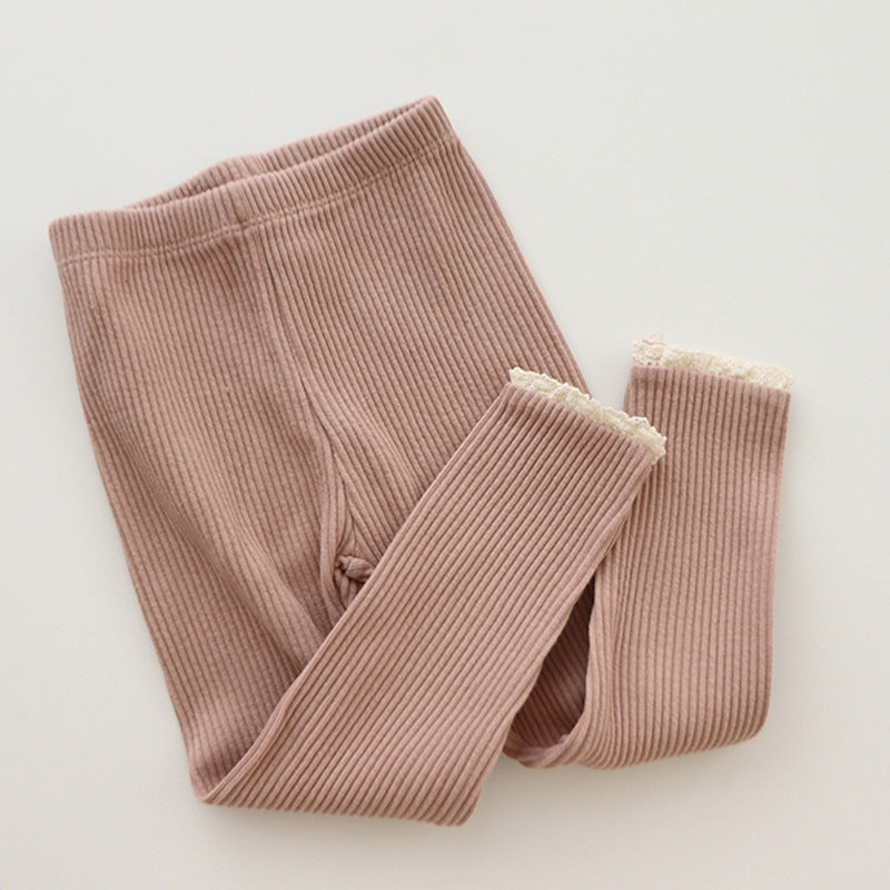 Baby girl in pink ribbed leggings with delicate lace trim, perfect for infant and toddler fashion, comfortable cotton knit