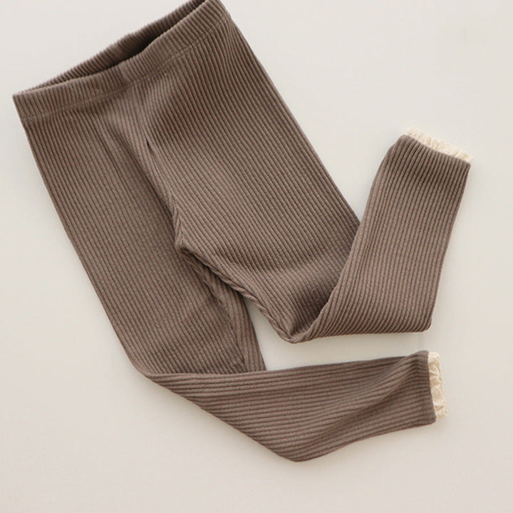 Toddler girl wearing comfortable ribbed cotton leggings with a sweet lace trim, suitable for everyday infant wear
