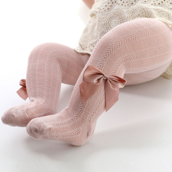 Baby girl's pink cotton blend tights with a decorative bow, perfect for spring and autumn infant clothing.