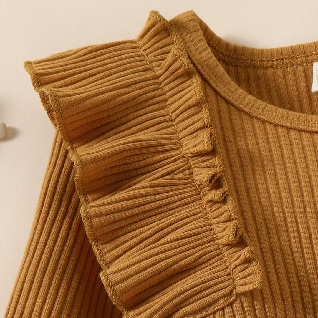 Pink knitted dress for baby girls, included in a winter ensemble with a warm turtleneck