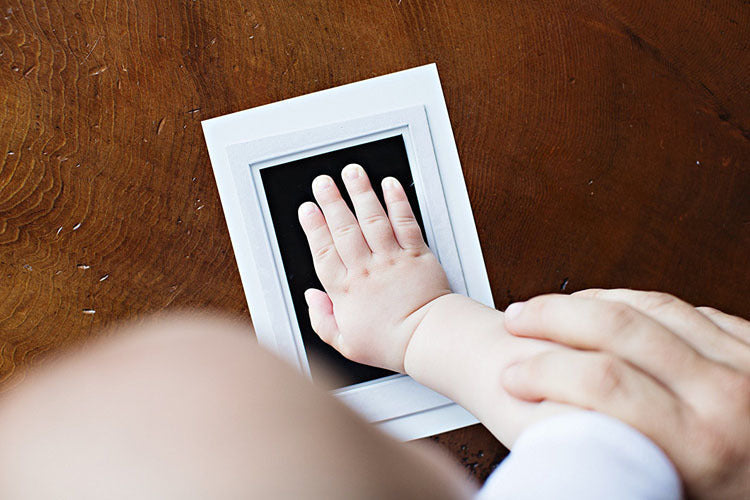 Adorable baby foot making a detailed footprint with the Mess-Free Ink Keepsake Kit for memories.