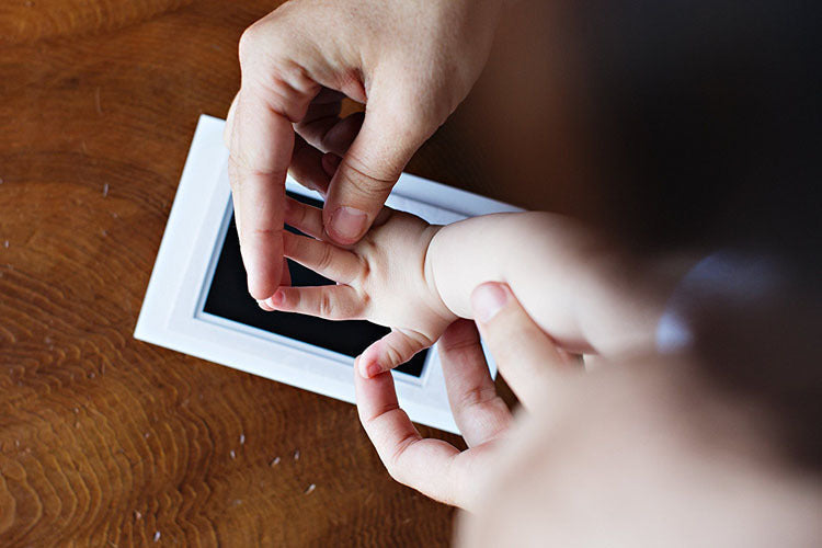 Contents of the Baby Handprint & Footprint Kit: mess-free ink pad, imprint cards, instructions.