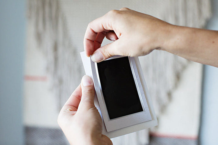 Small baby hand on the non-toxic, mess-free ink pad for a safe, easy handprint keepsake.